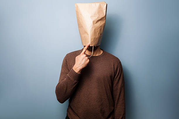 Stupid young man with a brown paper bag over his head